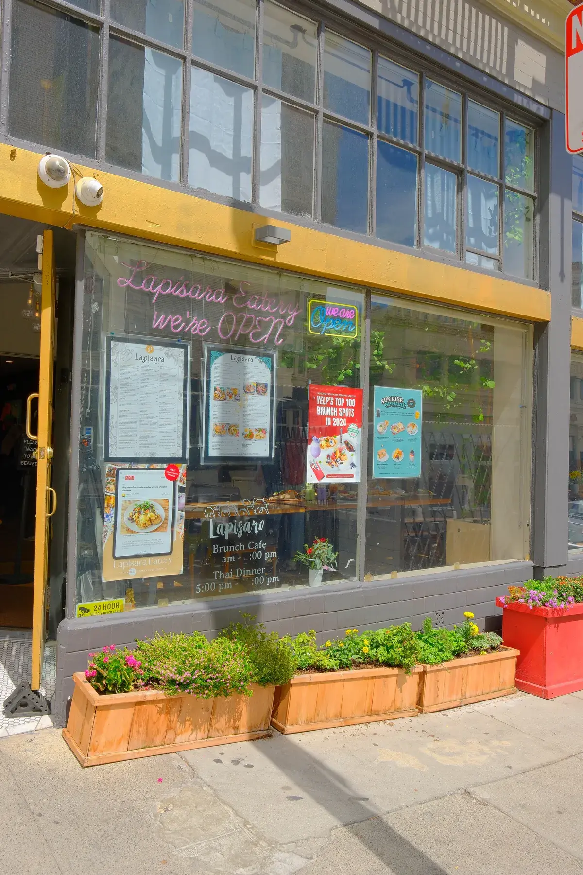 The Lapisara window on Post Street with planters along the sill