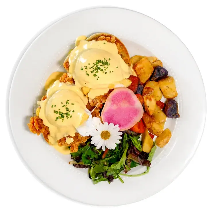 Eggs benedict with hollandaise, breakfast potatoes and salad